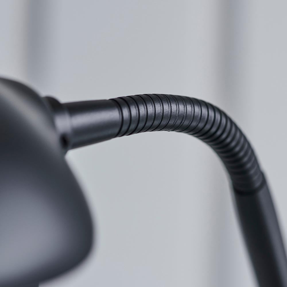 Close-up of the Endon Cliffcombe Floor Lamp's matt black flexible reading arm and shade joint against a light grey background.