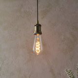 Endon 4W E27 LED filament twist bulb with clear pear-shaped glass and warm amber spiral filament, suspended from an antique brass pendant holder.