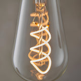 Close-up of Endon 4W E27 LED filament twist bulb showing the illuminated spiral filament within clear pear-shaped glass, glowing warm white.