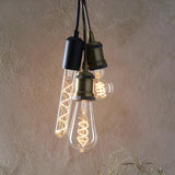 Endon 4W E27 LED filament bulbs with twisted warm white filaments in clear glass, shown in a cluster of pendant fittings with black and brass holders.