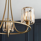 Close-up of Endon Clementine 3 light semi-flush ceiling light in brass with faceted glass shades, shown lit against a dark panelled wall.