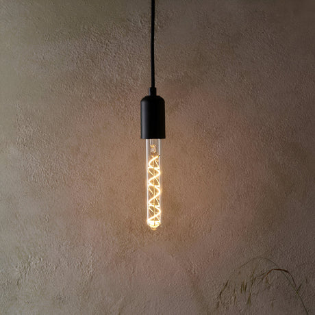 Endon 4W E27 LED filament spiral bulb in a clear tubular glass, warm white glow, fitted in a matte black pendant holder against a textured beige wall.