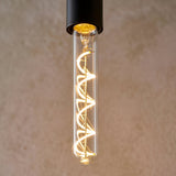 Endon 4W E27 LED filament bulb with clear tubular glass and a warm white spiral filament, shown lit in a matte black pendant holder.