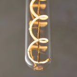 Close-up of Endon 4W E27 LED filament spiral bulb with clear tubular glass and warm white glowing coiled filament against a grey background.
