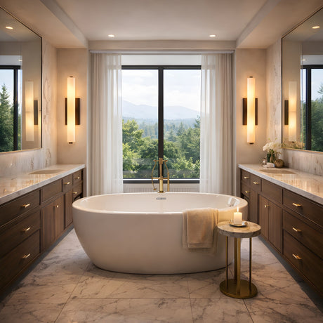 A modern bathroom showcases a freestanding white tub on marble floors, wooden vanities with tall mirrors, and the Selvara LED Large Alabaster Wall Light in matte black and soft white casting a gentle glow beside a window with scenic views.