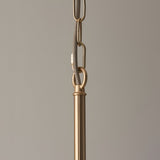 Close-up of the Cliffleigh 5 Light Pendant's brass chain and grey braided fabric flex meeting the brushed brass rod, on a plain neutral background.