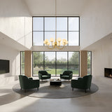A modern living room with floor-to-ceiling windows, four green armchairs around a round coffee table on a circular rug, a fireplace, garden views, and an Aurelio 8 Light Large Globe Alabaster Chandelier in soft white & brushed brass.