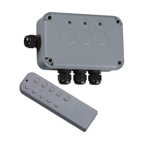 An IP66 3 Gang Remote Switch Box, featuring a gray weatherproof electrical junction box with three round connectors and a cable gland, is placed beside an elegant remote control equipped with six buttons. The durable switching unit boasts raised circular designs on its surface to ensure it withstands the toughest conditions.