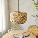 Endon Cranley pendant shade in natural handwoven rattan with a soft rounded open weave, hung above a wooden dining table beside a rattan chair.