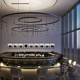 Skybell Circle Iron Ring LED Pendant Light in Ebony Black, tiered circular rings with multiple cone-shaped heads on slim stems, shown above a curved bar in a restaurant setting.