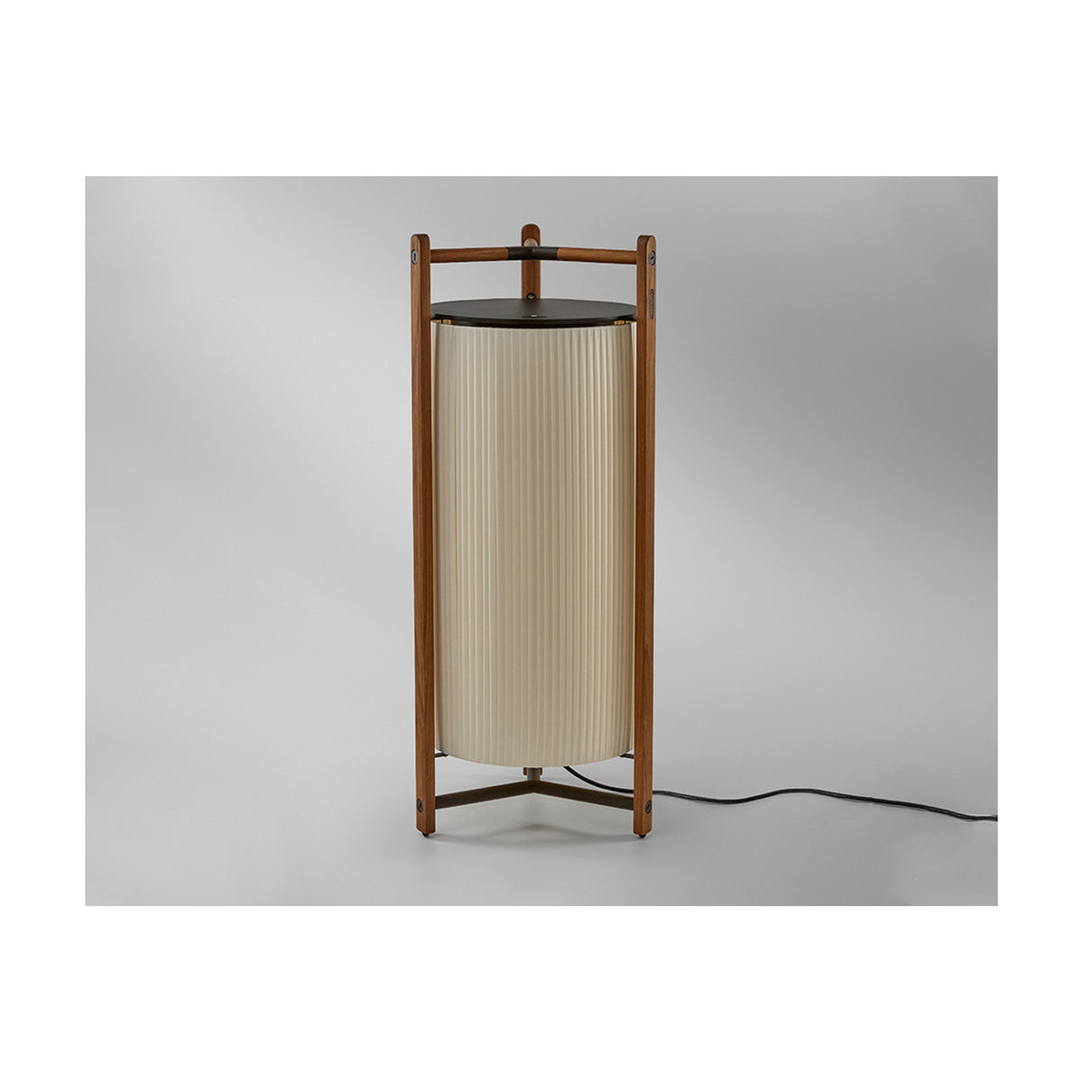 Kando P/111 Ribbon LED floor lamp with a pleated cream fabric cylinder shade, dark top disc, and wooden tripod frame, shown against a plain light background.