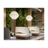 Mos 02 Ribbon Tiered Pendant Light in white translucent pleated fabric with iron frame, shown in pairs above booth seating in a restaurant dining area with greenery backdrop.