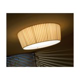 Plafonet 60 Ribbon LED ceiling light with pleated beige drum shade and white diffuser, mounted flush against a ceiling for soft ambient light.
