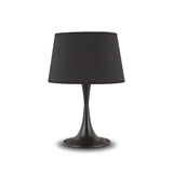 The Arc Large Table Lamp - Black features a sleek design with a slender base and a stylish shade, all standing on a circular platform, epitomizing minimalist aesthetics. Its elegant construction seamlessly complements modern interiors, making it an ideal addition to contemporary spaces.