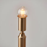 Close-up of the Endon Cranwick LED table lamp's brushed brass stem with lit integrated LED globe bulb, shown against a plain light background.