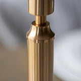 Close-up of the Endon Cranwick LED table lamp's brushed aged brass stem, showing the reeded column and tailored collar detail.