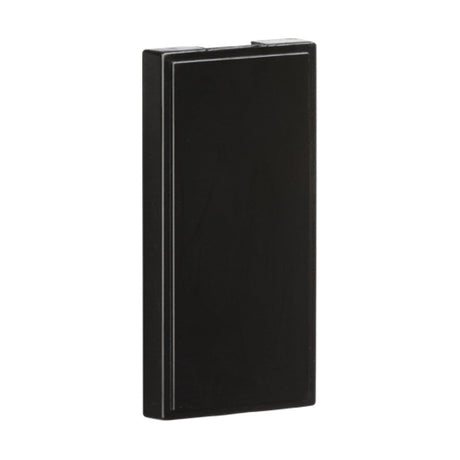 A black, rectangular device from the PACK OF 10 - Half Blanking Modules (25 X 50mm) collection, featuring a sleek and minimalist design with an ABS construction. There are no visible buttons or logos, and it is angled slightly to highlight its slim profile against a white background.