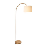 Endon Bevbourne arc floor lamp with a warm brass curved stem, round base, and tilting natural fabric drum shade, shown on a plain white background.