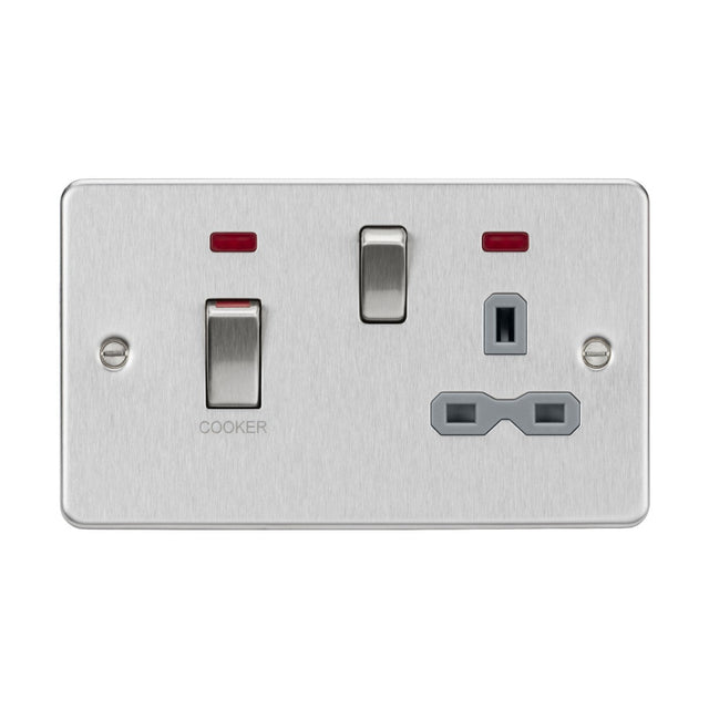 The product, named "45A DP Switch & 13A Socket Neons - Brushed Chrome (Grey Insert)," includes a brushed chrome double switch socket with a labeled 45A Cooker switch on the left and a standard three-pin power outlet on the right, each featuring red indicator lights above.