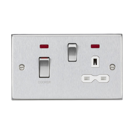 The 45A DP Switch & 13A Socket Neons in brushed chrome, with a white insert and square edge design, features a switch labeled COOKER, along with a standard power socket. Two small red indicator lights are positioned above the switches to ensure functionality at a glance.