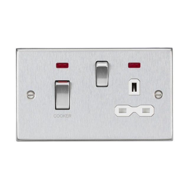 The 45A DP Switch & 13A Socket Neons in brushed chrome, with a white insert and square edge design, features a switch labeled COOKER, along with a standard power socket. Two small red indicator lights are positioned above the switches to ensure functionality at a glance.