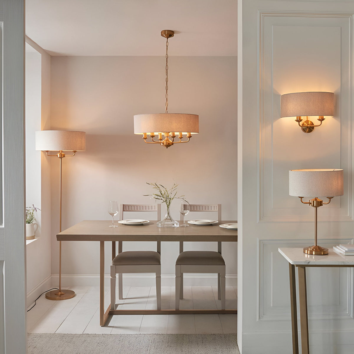 Endon Brenley 6 light pendant in vintage brass with natural linen drum shade, shown with matching floor, wall and table lamps in a dining room.