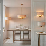 Endon Brenley 6 light pendant in vintage brass with natural linen drum shade, shown with matching floor, wall and table lamps in a dining room.
