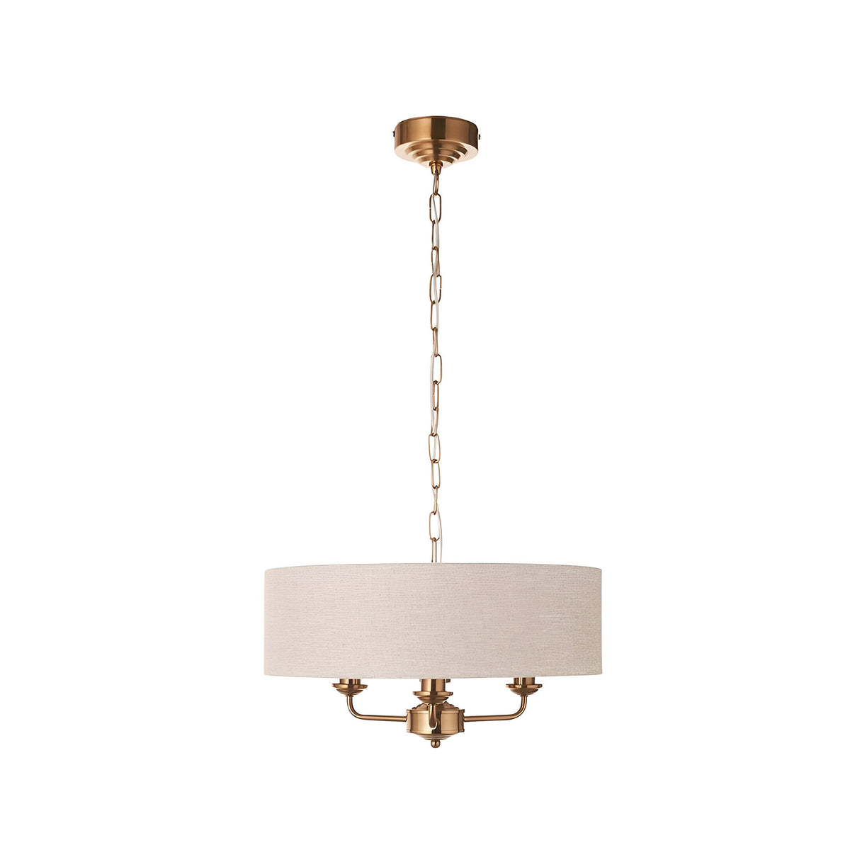 Brenley 3-light pendant with a natural linen drum shade on vintage brass metalwork and chain suspension, shown against a plain white background.
