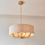 Endon Brenley pendant light with a large natural linen drum shade and vintage brass frame holding multiple E14 lamps, suspended from a chain.
