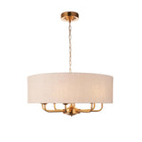 Endon Brenley pendant light with a wide natural linen drum shade and vintage brass frame holding six visible E14 arms, on a white background.