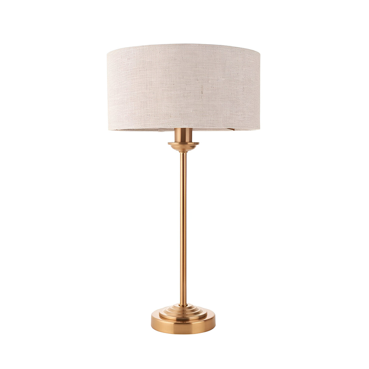 Endon Brenley table lamp with slim brass stem, stepped round base and natural linen drum shade, shown on a plain white background.