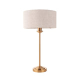 Endon Brenley table lamp with slim brass stem, stepped round base and natural linen drum shade, shown on a plain white background.