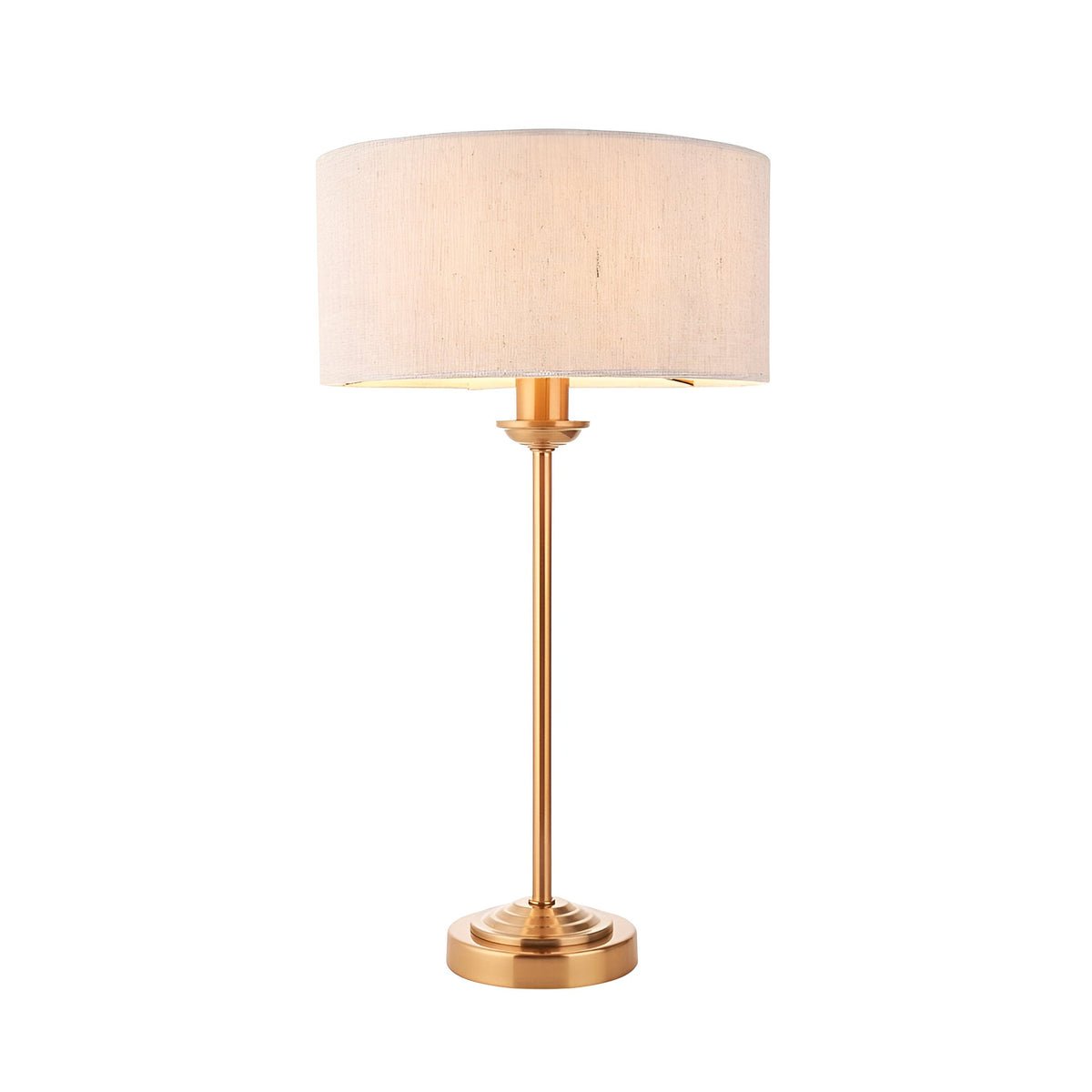 Endon Brenley table lamp with slim brass stem, rounded base and natural linen drum shade, shown on a plain white background.