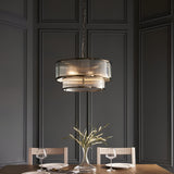 Endon Rothbury 5 light pendant in antique brass with two tiers of clear ribbed glass panel shades, suspended by chain in a panelled dining room.