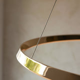Close-up of the Cliffton LED Pendant in gold, showing the glossy ring frame, white diffuser, and slim suspension cable against a neutral background.