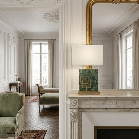Elegant living room with ornate white walls, a gold-framed mirror above a marble fireplace, and the Veridan 1 Light Framed Marble Table Lamp in brass & green. Green furniture and large windows with beige curtains add sophistication.