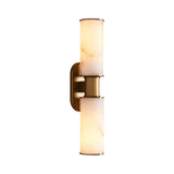 The Lumara 2 Light Twin Tube Alabaster Wall Light in soft white and brushed brass features two cylindrical alabaster shades stacked vertically on a sleek brass base, softly illuminating any space.