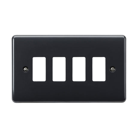 The 4 Gang Grid Faceplate [Part M Compliant] is a black electrical faceplate that meets British Safety standards and features four rectangular cutouts for switches or outlets. It is secured with two screws on the sides.