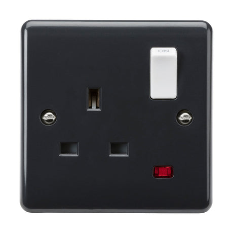 The 13A 1 Gang DP Switched Socket Neon [Part M Compliant] showcases a modern black design with a white on/off switch and belongs to the Curved Edge range. It features two plug holes, along with a small red indicator light. The minimalistic design blends functionality and style, with visible screws securing it to the surface.