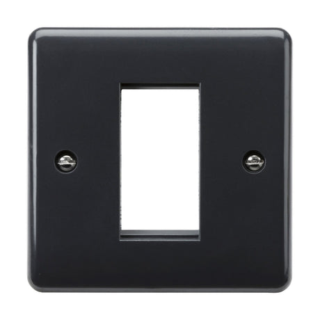 Introducing the 1 Gang Modular Faceplate [Part M Compliant], a sleek black switch plate cover with a rectangular cutout tailored for rocker switches. It has elegantly curved edges and two screw holes, one on each side, for easy installation. This wiring accessory offers both functionality and style.