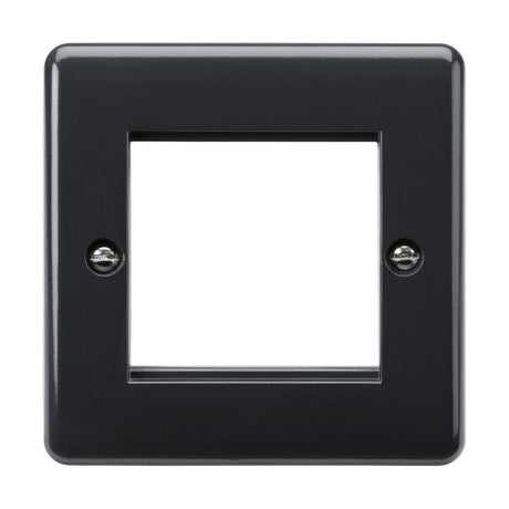The 2 Gang Modular Faceplate [Part M Compliant] is a black plastic faceplate featuring a square cutout in the center, specifically designed for light switches or outlets. It boasts anti-microbial properties and includes two visible screws at the top and bottom for easy mounting, ensuring seamless integration with your wiring accessories.