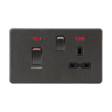 Introducing the 45A DP Switch & 13A Neon Socket in a sleek smoked bronze finish, featuring a black insert. This elegant switch includes red indicator lights and a clearly labeled COOKER switch with a robust 45A capacity. The socket accommodates two power plugs with both vertical and horizontal prong configurations, housed in a sophisticated screwless design for seamless installation.