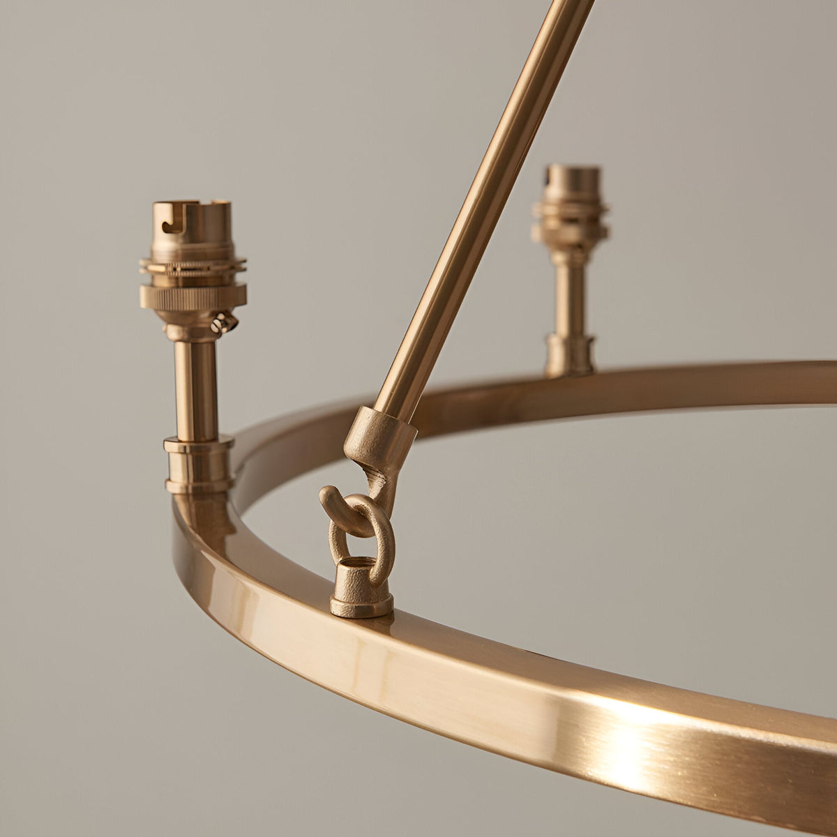 Close-up of the Endon Bevford 6 Light Pendant showing the aged brass hoop, B22 lamp holders, and central suspension loop against a light background.