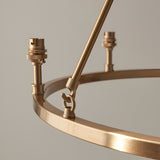 Close-up of the Endon Bevford 6 Light Pendant showing the aged brass hoop, B22 lamp holders, and central suspension loop against a light background.