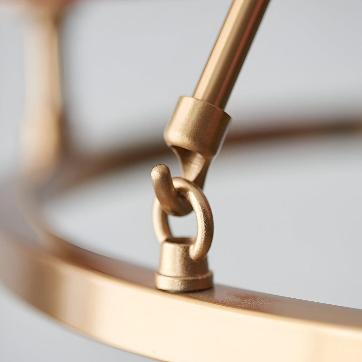 Close-up of the Endon Bevford 6 Light Pendant showing the aged brass hoop, central suspension loop, and adjustable rod fitting.