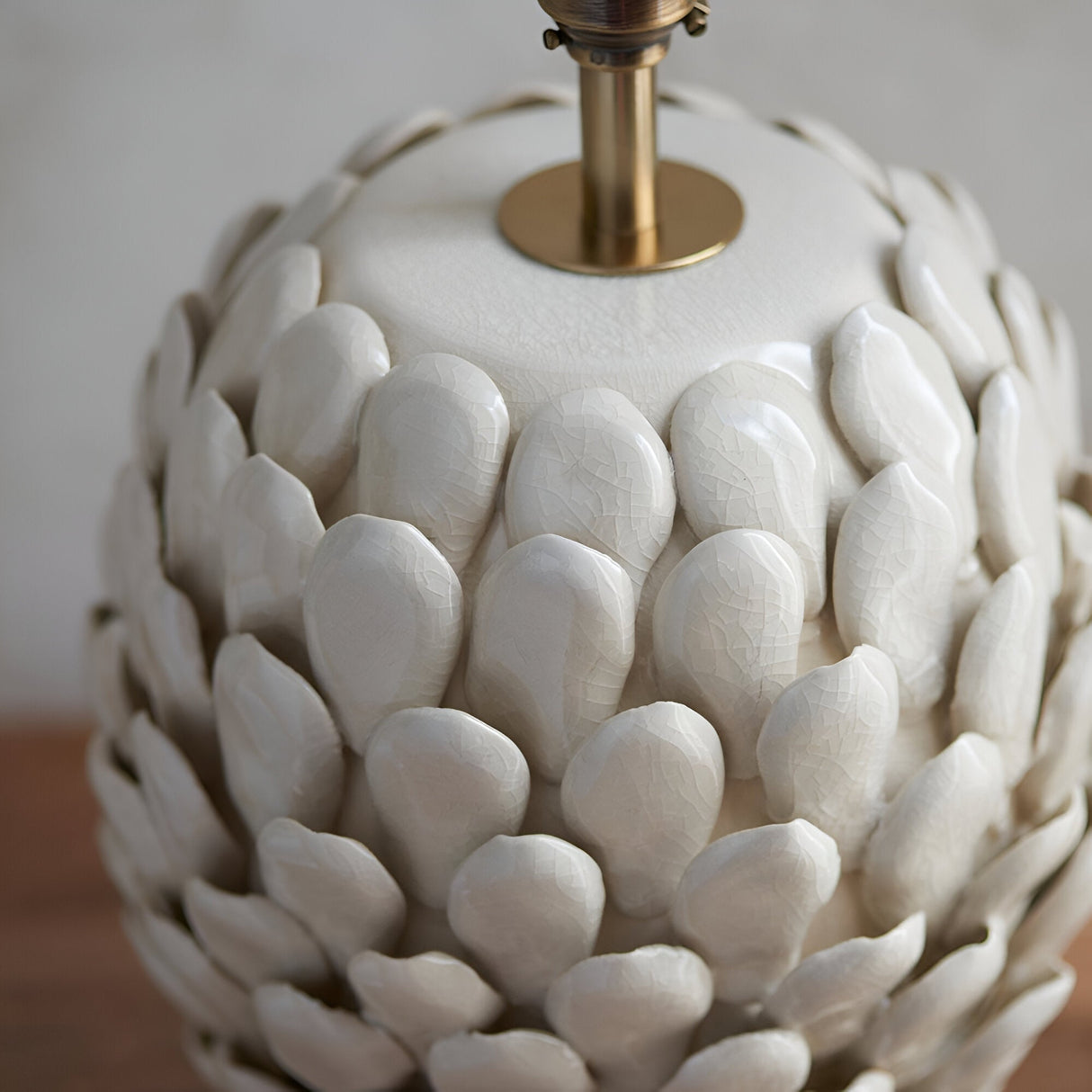 Caldford Small Table Lamp base in cream, close-up of ceramic leaf-shaped textured body with crackle glaze and brass fitting.