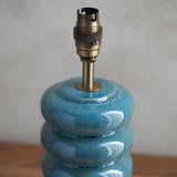 Cliffstead Table Lamp base in blue reactive ceramic glaze with stacked curved form, topped with a brushed antique brass switched B22 lamp holder.