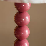 Close-up of the Endon Brenleigh table lamp base showing stacked glossy pink metal spheres against a neutral background.