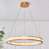 Endon Bevley large LED ring pendant in brushed gold with ribbed frosted acrylic diffuser, suspended on clear cables against a white panelled wall.