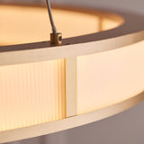 Close-up of the Endon Bevley Ring Pendant in brushed gold, showing the ribbed frosted acrylic diffuser and clear suspension cable fitting.